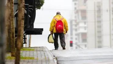 Homem vestindo jaqueta amarela para se proteger do frio em Curitiba.