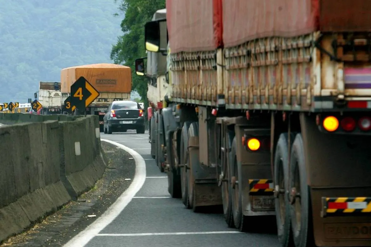 Imagem mostra um caminhão trafegando pela BR-277 com o pisca ligado.