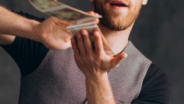 Man with banknotes isolated in studio